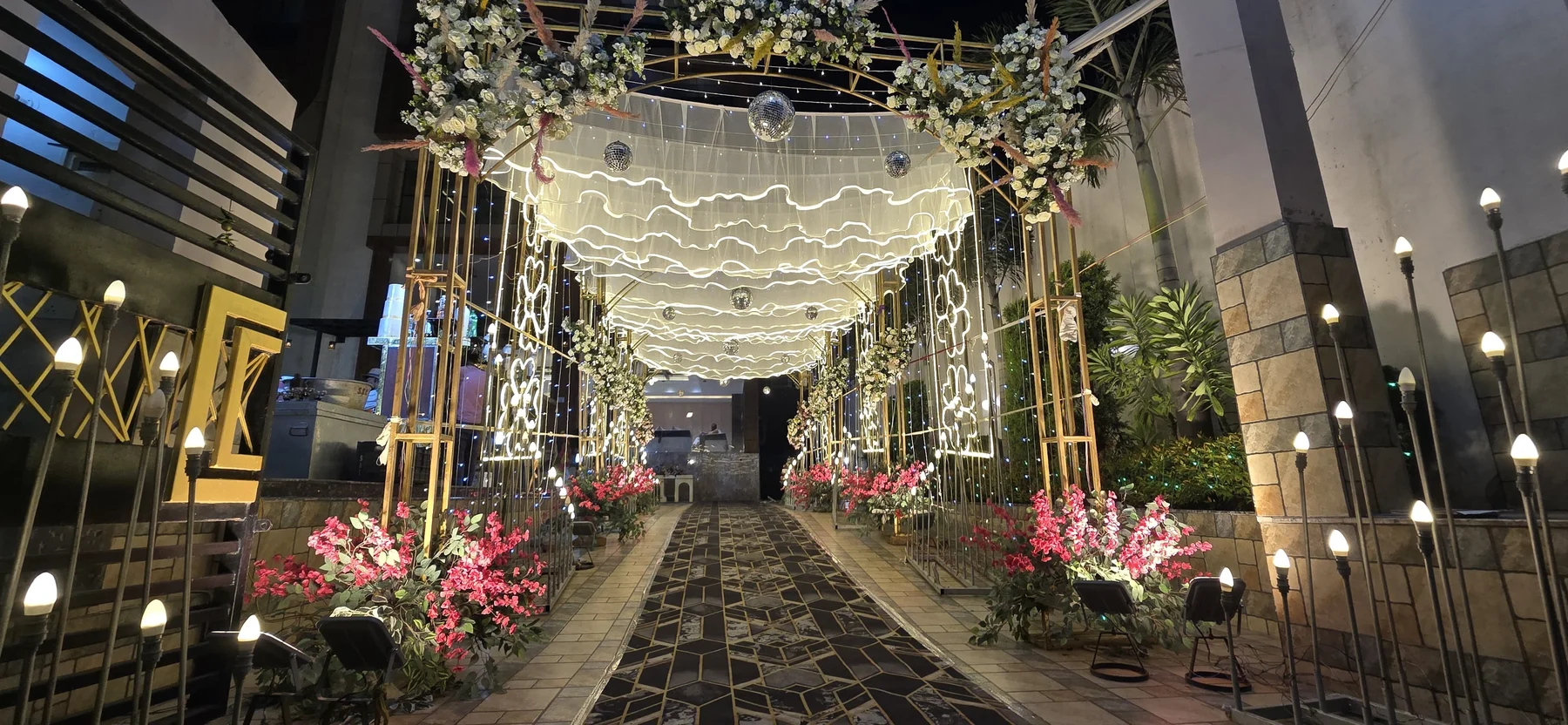 Floral event entrance at SB International with decorative lights
